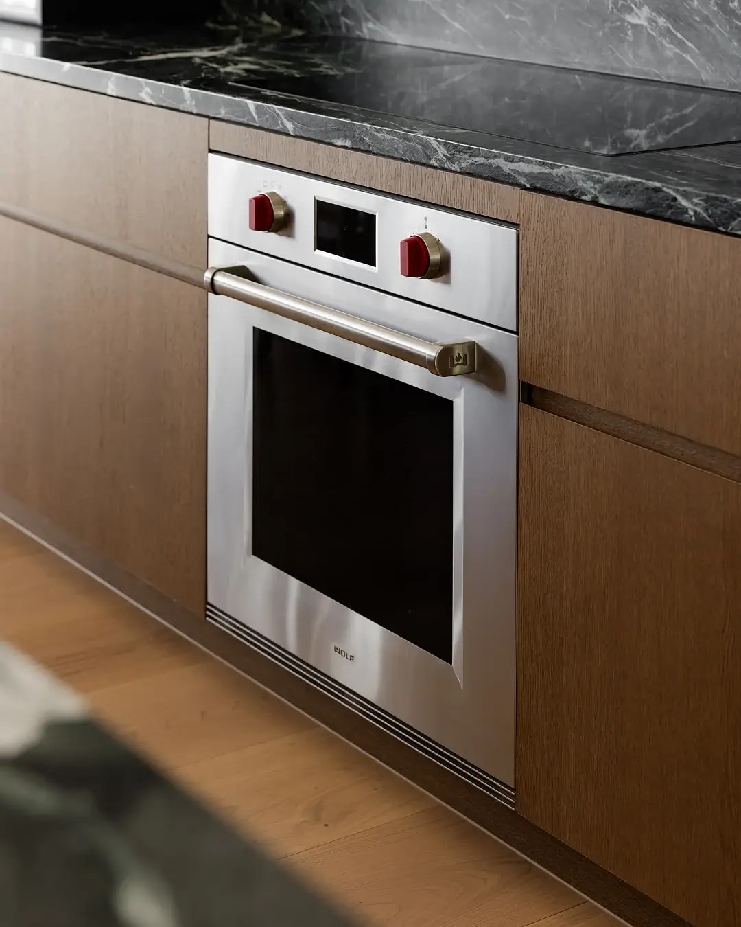Kitchen cabinetry in a Red Hill home in Havwoods' Bayonne timber veneer with integrated built-in oven.